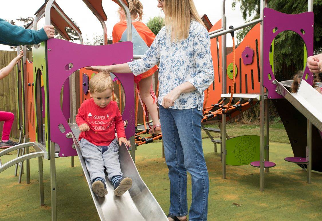 children going down the slide at usk park